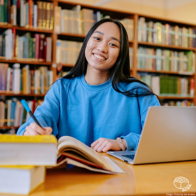 Girl writing in library